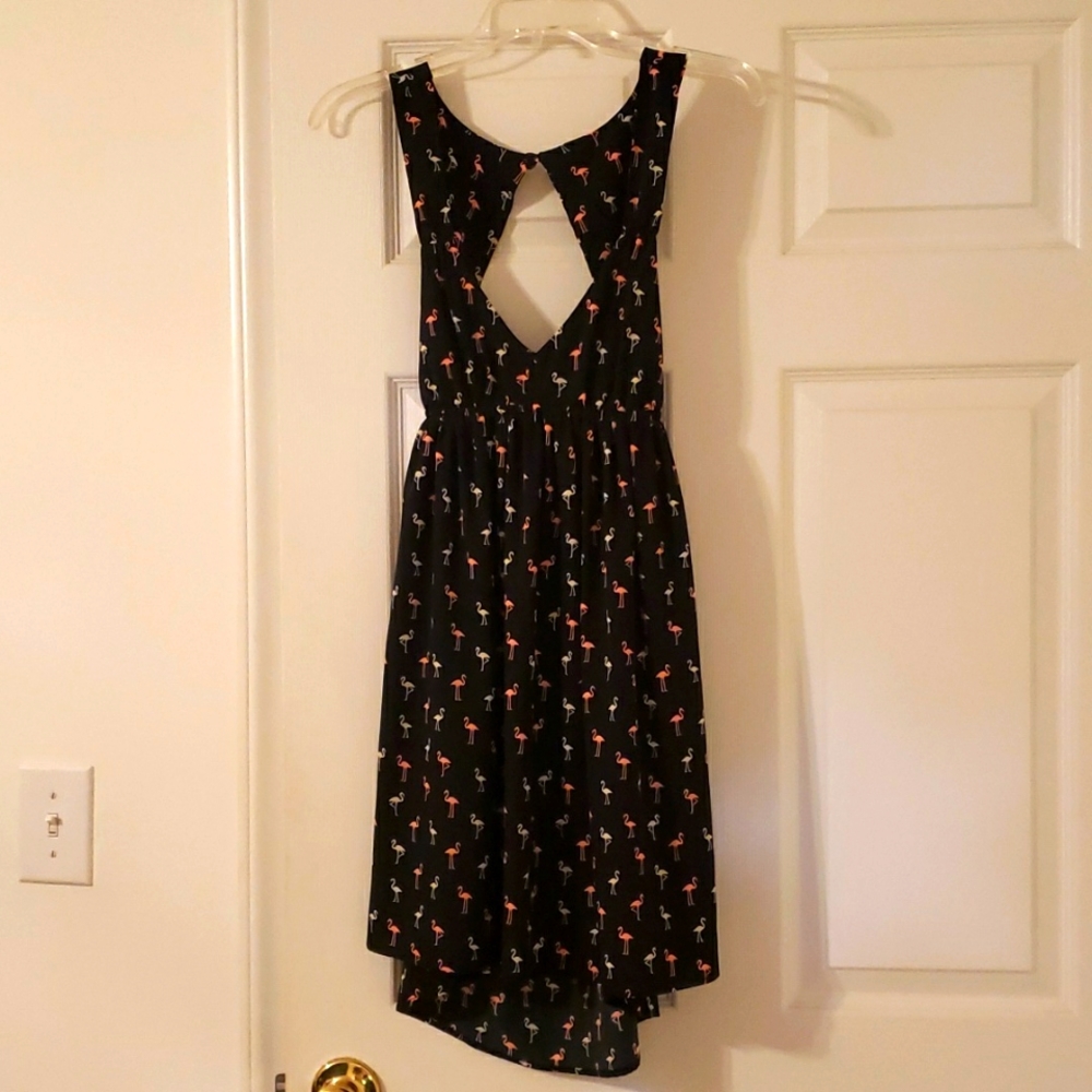 Cute flamingo dress with cut out back and low neckline.